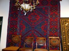 AN ANTIQUE CAUCASIAN SOUMACK CARPET.