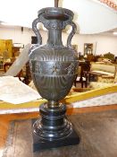 A PAIR OF PATINATED BRONZE CLASSICAL STYLE URN FORM TABLE LAMPS ON BLACK MARBLE BASES. APPROX