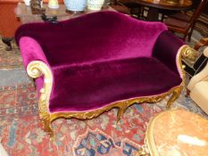 A CARVED GILT SHOW FRAME ITALIANATE SMALL SETTEE. APPROX 155cms WIDE.