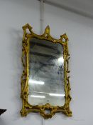 AN ANTIQUE GEORGIAN CARVED GILTWOOD MIRROR