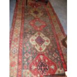 AN ANTIQUE CAUCASIAN TRIBAL RUNNER. 300 X 135CM