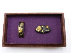 **A FINE MID 17TH CENTURY MATCHING FUCHI AND KASHIRA, DECORATED WITH BUILDINGS AND VINES,