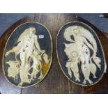 A PAIR OF ANTIQUE CAST IRON PLAQUES RELIEF CAST WITH CLASSICAL MAIDENS.
