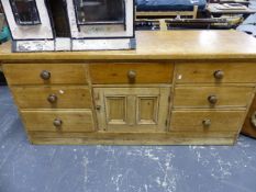 A 19TH.C.PINE DRESSER BASE WITH SEVEN DRAWERS AND CUPBOARD. 184cms WIDE.