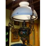 A LATE VICTORIAN HANGING CHANDELIER WITH CERAMIC AND GLASS OIL RESERVOIR.