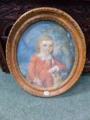 ENGLISH 18/19TH.C.SCHOOL AN OVAL PORTRAIT OF A BOY WITH HIS DOG, MOULDED OVAL GESSO FRAME.