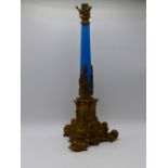 A LATE 19TH CENTURY FRENCH GILT METAL LAMP BASE WITH BLUE GLASS STEM AND SCROLLED FEET. (50CMS