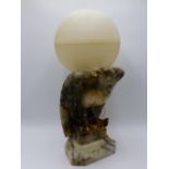 A CONTINENTAL ART DECO ALABASTER TABLE LAMP CARVED AS AN EAGLE WITH GLOBE FORM ALABASTER SHADE.