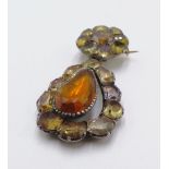 A 19TH CENTURY WHITE METAL AND ORANGE PASTE STONE SET ARTICULATED FLORAL BROOCH.