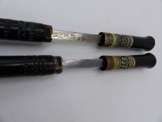 TWO INDIAN SWORD STICKS WITH BRASS AND BONE MOUNTS.