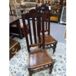 A PAIR OF CARVED OAK 18th.C.PANEL SEAT HIGH SLAT BACK CHAIRS.