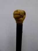 A 19TH CENTURY ENGLISH OR EUROPEAN CARVED IVORY TOP WALKING CANE WITH HANDLE IN THE FORM OF HAND