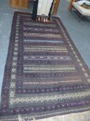 AN UNUSUAL BELOUCH TRIBAL MIXED TECHNIQUE RUG. 304X158CMS