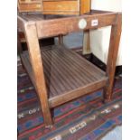 AN EARLY 20TH.C.TEAK TWO TIER SERVING TROLLEY, CONSTRUCTED FROM THE TIMBERS OF HMS ARETHUSA.