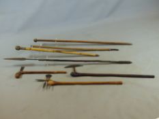 A COLLECTION OF INTERESTING AFRICAN CEREMONIAL AXES, STAFFS AND SPEARS.