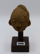 AN ANTIQUE TRIBAL CARVED STONE PESTLE OR POUNDER TOGFETHER WITH AN AFRICAN SANDSTONE CARVED HEAD,