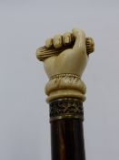 A 19TH CENTURY ENGLISH OR EUROPEAN IVORY TOP WALKING CANE WITH HANDLE FINELY CARVED IN THE FORM OF