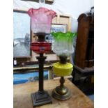 A 19TH.C.OIL LAMP WITH CRANBERRY GLASS RESERVOIR AND SHADE AND A FURTHER VICTORIAN OIL LAMP WITH