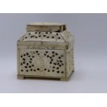 AN UNUSUAL 19TH.C.EUROPEAN CARVED AND PIERCED IVORY CASKET RAISED ON BRACKET FEET. 13.5CMS WIDE