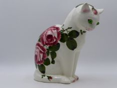 A PLICHTA POTTERY FIGURE OF A CAT WITH ROSE BLOSSOM DECORATION. 26CMS HIGH.