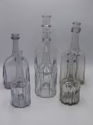 SIX ANTIQUE GLASS DECANTERS OF SHAPED MALLET FORM WITH RINGED NECKS.