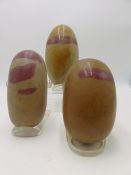 THREE INDIAN SHIVA LINGAM STONE OF LARGE SIZE EACH OF GREYISH STONE WITH RED LINE INCLUSIONS.