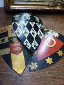 A GROUP OF THIRTEEN ANTIQUE TOLE PAINTED ARMORIAL CRESTS.