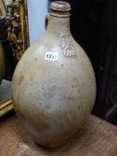 AN EARLY STONEWARE BELLAMINE FLAGON. 46CMS HIGH.