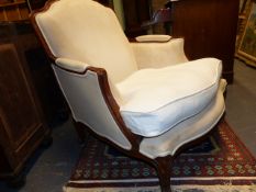 A LARGE FRENCH WALNUT SHOW FRAME SALON ARMCHAIR.