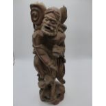 AN ORIENTAL CARVED HARDWOOD FIGURE OF A WIZENED TRAVELLER. 46 CMS. HIGH