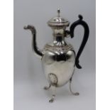 A FRENCH SILVER THREE FOOTED COFFEE POT WITH MYTHICAL CREATURE MASKED SPOUT AND EMBOSSED BORDER.