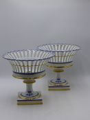 A PAIR OF ANTIQUE OLD PARIS PORCELAIN RETICULATED FOOTED FRUIT STANDS, CRESTED. 21CMS HIGH.