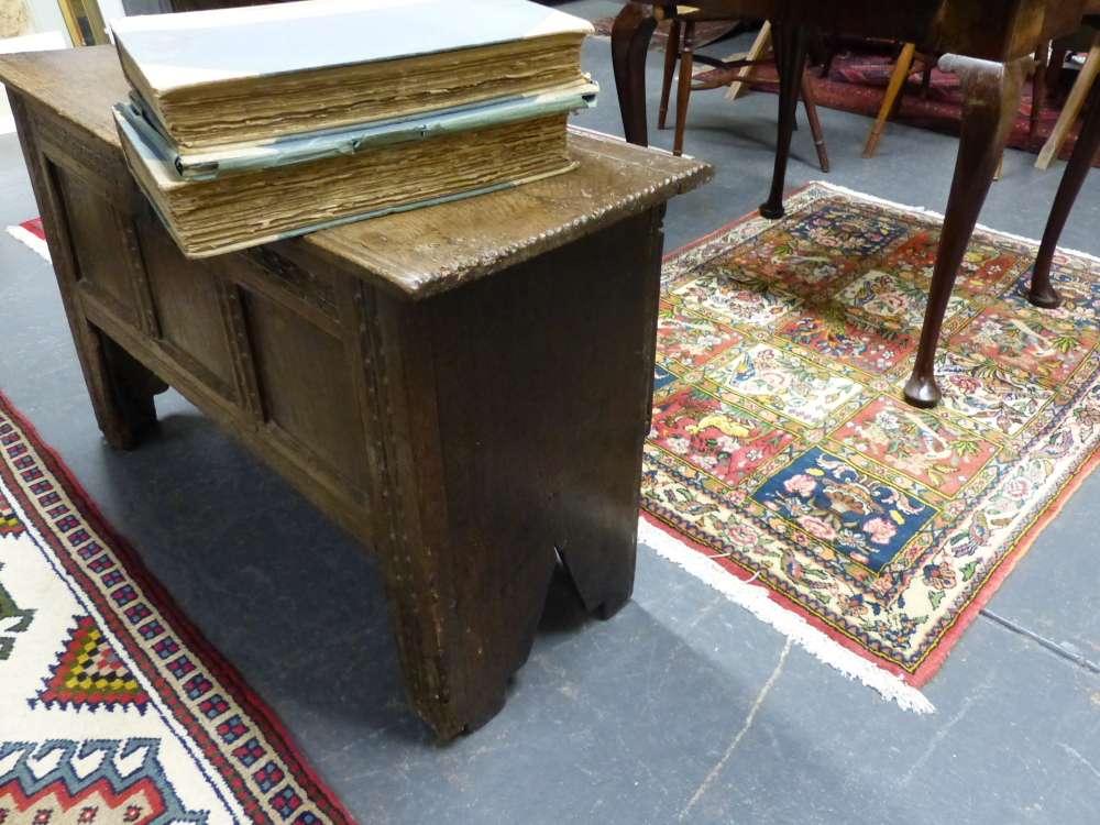 AN EARLY CARVED OAK COFFER WITH THREE PANEL FRONT, UNUSUALLY HIGH STILE FEET WITH PLANK CUT OUT - Image 2 of 2