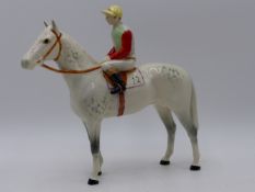 A BESWICK FIGURE OF A HORSE AND JOCKEY. 20CMS HIGH.