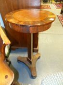 AN INLAID ROSEWOOD LATE REGENCY ROUND TABLE/JARDINIERE WITH INSET TOP AND TRIFORM PLATFORM BASE ON