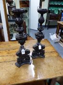 A PAIR OF ITALIANATE CARVED WOOD CANDLESTICKS CONVERTED FOR ELECTRICITY. 56CMS HIGH.