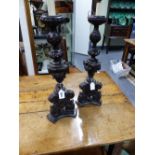 A PAIR OF ITALIANATE CARVED WOOD CANDLESTICKS CONVERTED FOR ELECTRICITY. 56CMS HIGH.