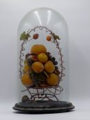 A 19TH.C.DISPLAY OF WAX FRUIT IN A WIREWORK BASKET ON TURNED BASE WITH GLASS DOME.