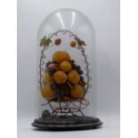 A 19TH.C.DISPLAY OF WAX FRUIT IN A WIREWORK BASKET ON TURNED BASE WITH GLASS DOME.