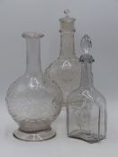 THREE ANTIQUE GLASS DECANTERS, TWO OF BALUSTER FORM WITH CUT DECORATION, THE THIRD OF SHAPED