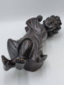 AN ANTIQUE CARVED WOOD FIGURE OF A CHILD WITH UP-STRETCHED ARMS. 42CMS HIGH