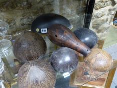 AN EASTERN BRASS MOUNTED AND INLAID COCONUT SHELL TOGETHER WITH A GOURD VESSEL AND VARIOUS COCONUT