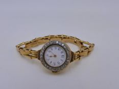 AN 18K STAMPED YELLOW METAL SWISS MADE MANUAL WOUND LADIES BRACELET WATCH. THE INSIDE CASE STAMPED