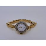 AN 18K STAMPED YELLOW METAL SWISS MADE MANUAL WOUND LADIES BRACELET WATCH. THE INSIDE CASE STAMPED