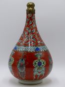AN UNUSUAL CHINESE FAMILLE VERTE BOTTLE FORM VASE WITH FLORAL AND SYMBOL DECORATION ON A ROUGE DE