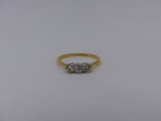 AN 18CT. YELLOW GOLD AND PLATINUM STAMPED THREE STONE DIAMOND CLAW SET RING.