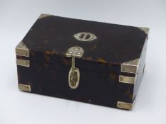 A TORTOISE SHELL HINGED BOX WITH WHITE METAL BOUND CORNERS AN INITIAL PLATE AND A LOCKING HASP.