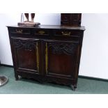 A CARVED OAK FRENCH PROVINCIAL SIDE CABINET, THREE DRAWERS ABOVE A TWO DOOR CUPBOARD SECTION WITH