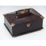 A CANTED LIDDED YELLOW METAL MOUNTED TORTOISE SHELL BOX ON IVORY FEET COMPLETE WITH WORKING LOCK AND