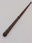 A 19TH CENTURY CARVED MAHOGANY BATON OF SHORT STAFF WITH REEDED DECORATION AND CARVED MONOGRAM, E.